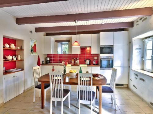 a kitchen with a wooden dining room table and chairs at Holiday Home in Huelgoat near Monts d'Arrée in Huelgoat
