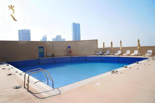 a large swimming pool on top of a building at Stylish Pearl 1BR - Chic Julphar Getaway in Abu Dhabi