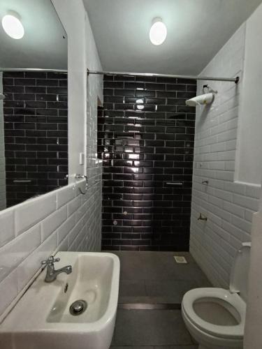 a bathroom with a sink and a toilet at Starla one bedroom duplex in Kinoo