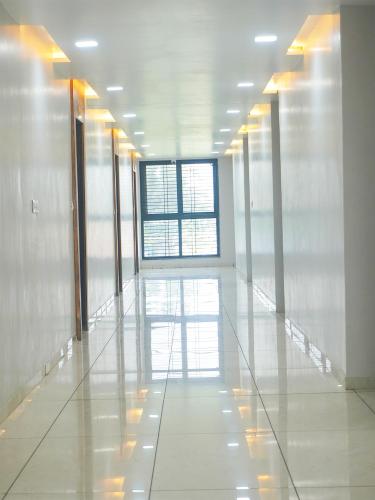 a hallway of an office building with a large window at Hotel Amazon in Himatnagar