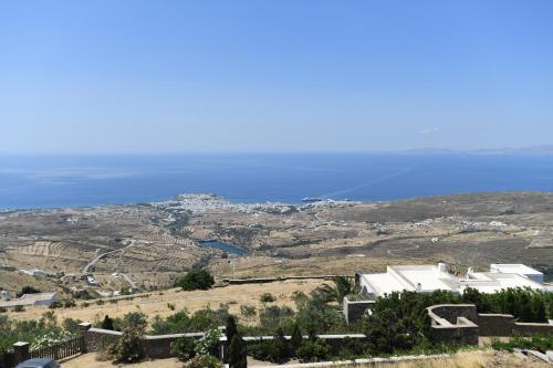 a view of a city and the ocean from a hill at Tinos Sky View Villa in Arnados