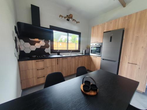 a kitchen with a table with a pair of shoes on it at L'écrin des calumets in La Plaine des Palmistes