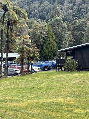 a group of cars parked in a parking lot at Lakes Lodge Okataina in Rotorua