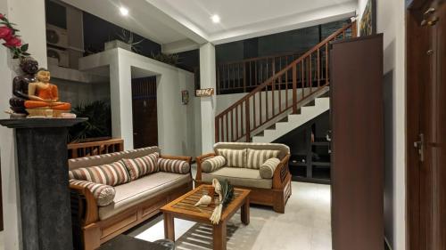 a living room with two couches and a staircase at Lagoon gate Tangalle Resort in Tangalle
