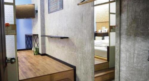 a door to a room with a bedroom and a bed at Cactus Resort & Hotel in Khon Kaen