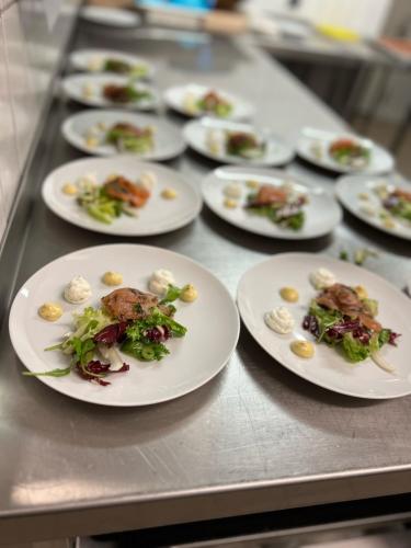 a row of plates of food on a table at Gålå Høgfjellshotell in Gålå