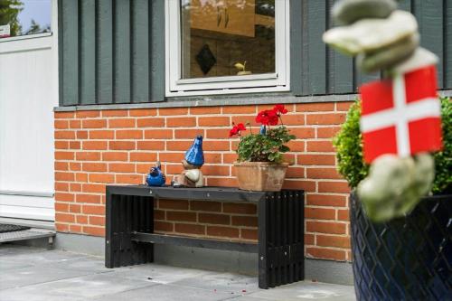 a bench in front of a brick building with a window at JB162-Fjerritslev-Ronnevej-4 in Fjerritslev