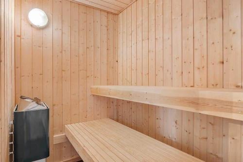 a wooden sauna with a wooden shelf and a light at SJ301-Hejls-Teglgardsvej-3 in Hejlsminde