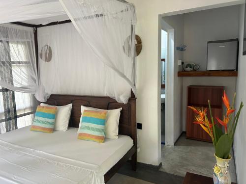 a bedroom with a bed with a canopy at Villa Bird Gate in Galle