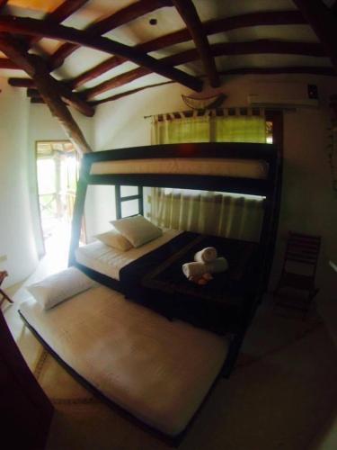 a bunk bed with a teddy bear on the bottom bunk at La Casa de Juan in Holbox Island