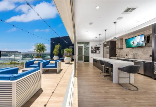 a kitchen with blue furniture and a large window at A Class Weho 2BD 2BA with Free Parking in Los Angeles