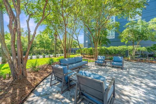 a group of chairs and tables in a park at Hilton Garden Inn Charleston Airport in Charleston