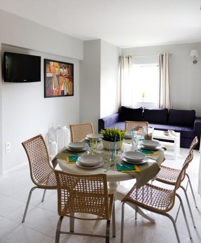 a dining room with a table and chairs at Regalo Apartments in Lygia