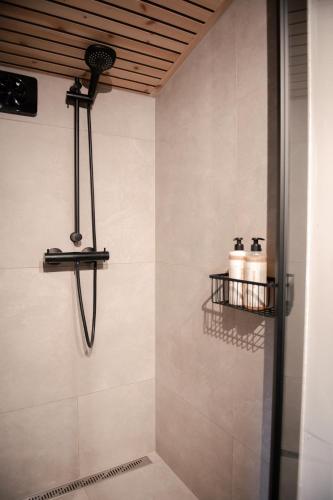 a bathroom with a shower with two toilets on the wall at Ådalsvollen Retreat -Go Wild for a While, Private Nature Getaway in Verdal