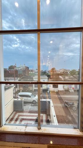 a view of a parking lot from a window at Raghukul by Namamispiritualyatra in Ayodhya