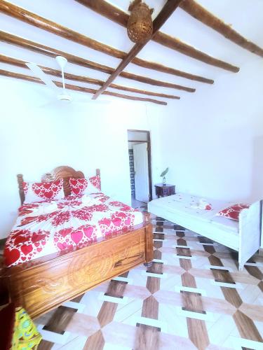 a bedroom with a bed and a checkerboard floor at Sweet Home in Kiwengwa