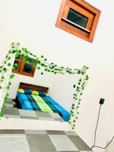 a bedroom with a bed with a ivy growing on it at Azure bay Donra in Gandara West