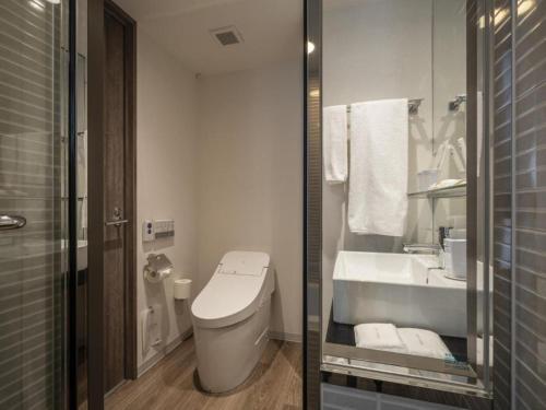 a bathroom with a toilet and a sink at Hotel Brighton City Osaka Kitahama in Osaka