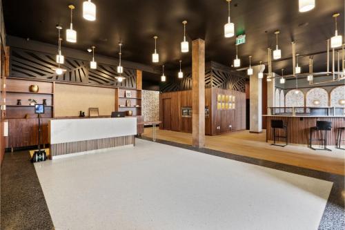 a rendering of the lobby of a church with a bar at Roami at The Lola Convention Center 1BR #17 in New Orleans