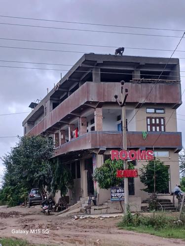 a building with a red sign in front of it at Hotel parshuram in BhÄdura