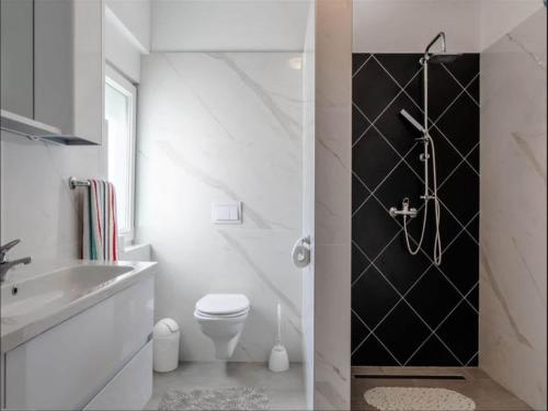 a white bathroom with a toilet and a sink at Villa in Vrsi with Pool near Sandy Beach in Vrsi