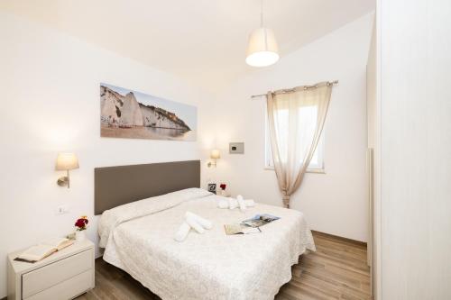 a white bedroom with a bed and a window at Detached villa with 2 bathrooms in Lupetto