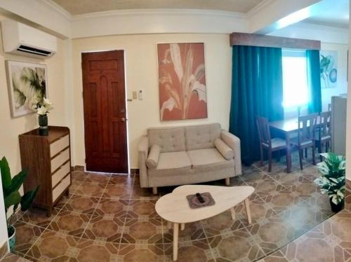 a living room with a couch and a table at Breakfast at Monaco - Palais Boracay in Boracay