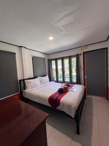 a bedroom with a large bed in a room at Revolution Hostel Pai in Pai