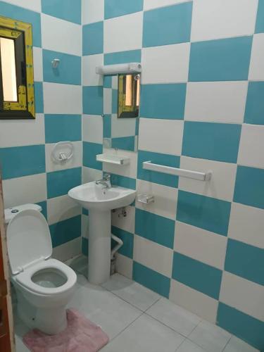 a bathroom with a toilet and a sink at Villa MBOLO in Pointe-Noire