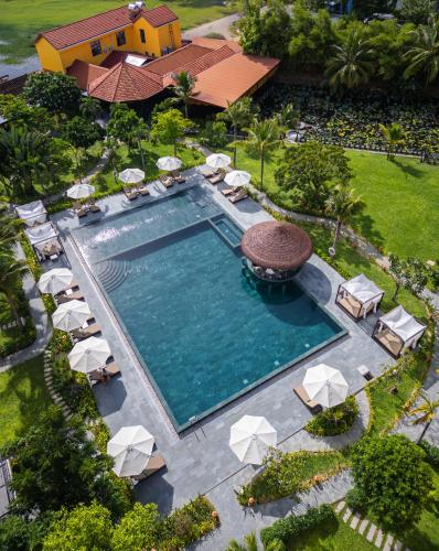 an overhead view of a swimming pool with umbrellas at Sen Village Hoi An in Hoi An