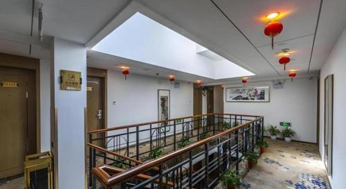 a hallway with a staircase in a building with lights at Huangshan Yupinglou Hotel in Huangshan