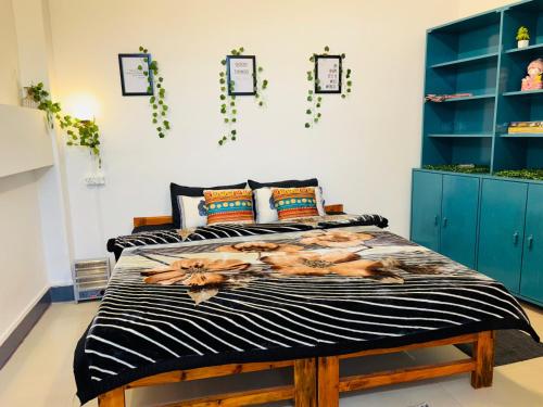 a bedroom with a bed and blue cabinets at Ammara's homestay , Shillong in Shillong