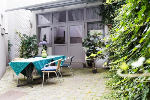 a table and chairs in front of a garage at Hotel Odeon in Vienna