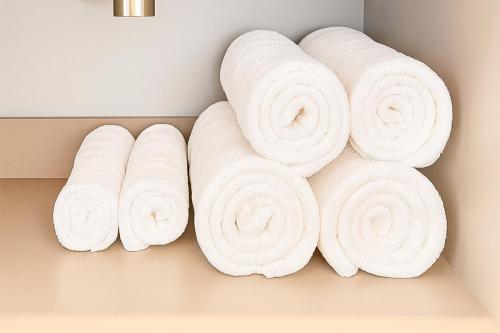 a bunch of rolled towels on a wall at Jungle Guardian - Rooftop Pool & Beach Club in Zona Hotelera Tulum in Tulum