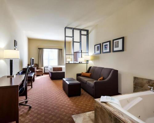 a living room with a couch and a tub in a hotel room at Comfort Suites near NASA - Clear Lake in Webster