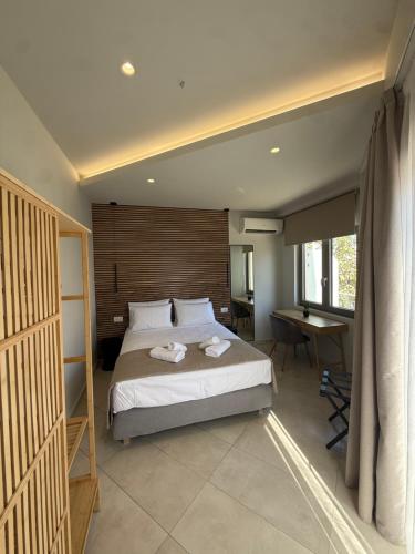 a bedroom with a bed and a desk in it at Chanioporta suites in Heraklio
