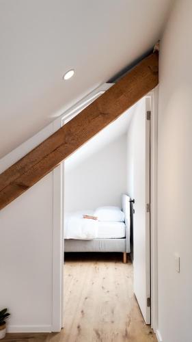 a bedroom with a bed in a attic at El Sart in Sart-lez-Spa