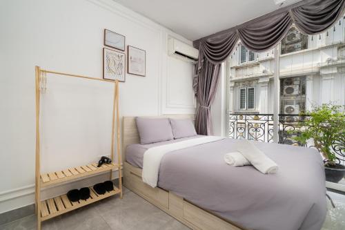 a bedroom with two beds and a window at V Living Lam Sơn in Ho Chi Minh City