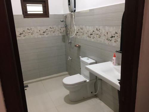 a bathroom with a toilet and a sink at Bosadi holiday home in Katunayake