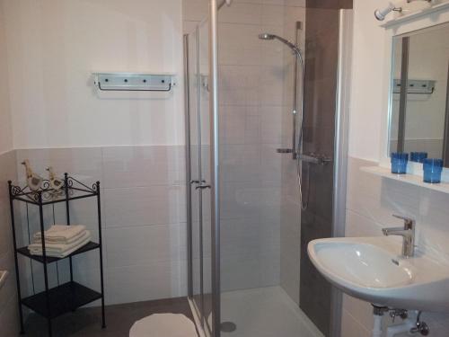 a bathroom with a shower and a sink at Haus am Bach in Fulpmes