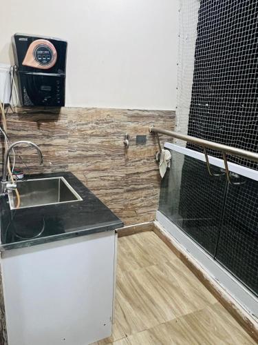 a kitchen with a sink and a counter top at Bansal Studio in Noida