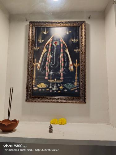 a picture of a painting on a wall at Ravis ishwaryam villa in Tiruchchendūr
