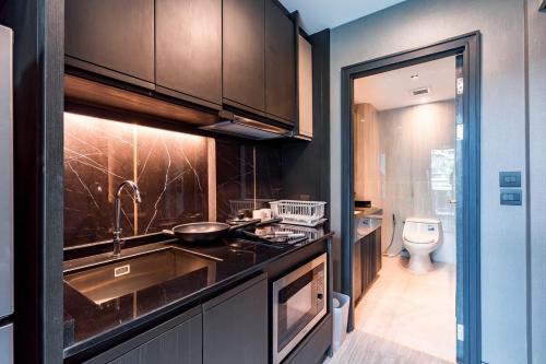 a kitchen with a sink and a toilet at Amazing Apartment with Pool 1BR Near Bazaar in Chiang Mai