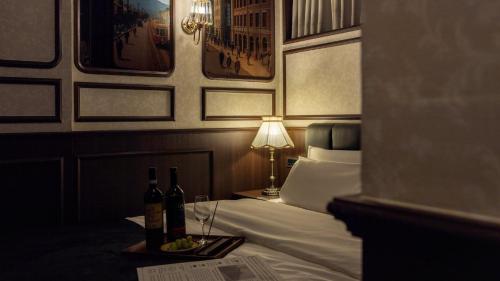 a hotel room with a bed with two bottles of wine at Stay Passport Express Gyeongseong Cheongnyangni in Seoul