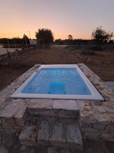 a pool of water on a stone structure at La Casa di Gioia - Dimora Rurale in Trappeto