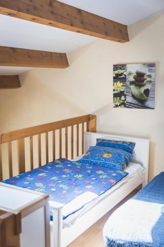 - une chambre pour enfants avec un lit bébé en bois et un oreiller bleu dans l'établissement HOLIDAYLAND BAIE DES OLIVIERS VILLA 36m2 1chambre fermée 6 couchages ou VILLA 41M2 2chambres fermées 7 couchages, à Narbonne-Plage