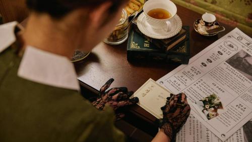 a woman looking at a book on a table at Stay Passport Express Gyeongseong Cheongnyangni in Seoul