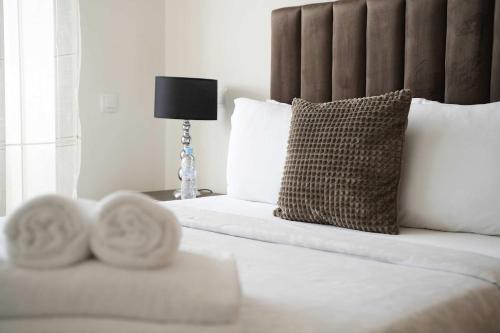 a bedroom with a bed with white sheets and pillows at Comfortable Getaway Near the Beach in Dar Ben Abdallah Ben Dehbi