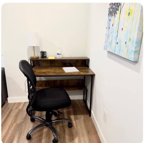 an office with a desk and a chair at Homey Basement Suite by Gaudi in Calgary