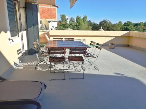 a table and chairs sitting on a patio at Apartment Grande Vista in Starigrad Paklenica with a large terrace in Starigrad-Paklenica